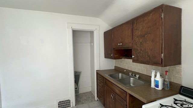 1009 W Armstrong Ave, Peoria, IL 61606 - kitchen with range, backsplash, and vaulted ceiling