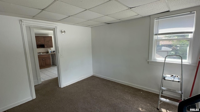 1009 W Armstrong Ave, Peoria, IL 61606 - spare room with a drop ceiling and dark colored carpet