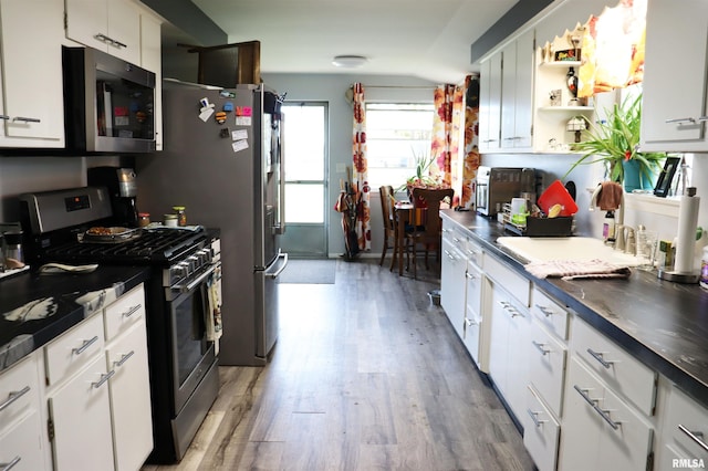 201 Willa Ln, Washington, IL 61571 - kitchen with appliances with stainless steel finishes, light wood-type flooring, open shelves, white cabinetry, and dark countertops