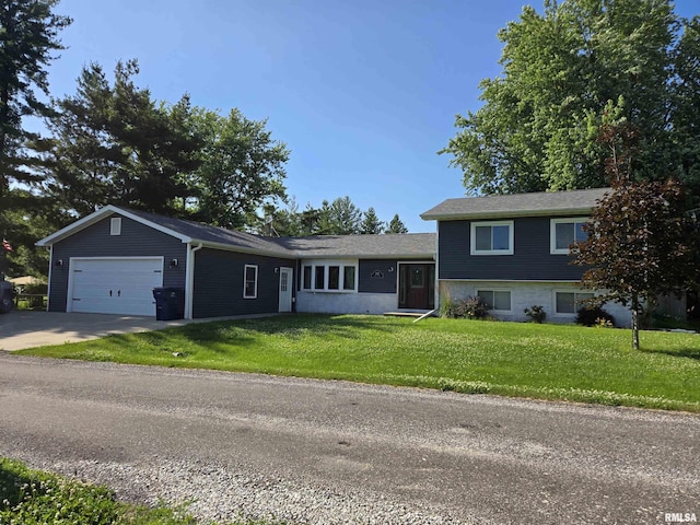 102 Conch Dr, La Harpe, IL 61450 - tri-level home featuring a garage, a front lawn, and concrete driveway