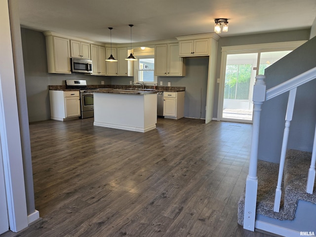 102 Conch Dr, La Harpe, IL 61450 - kitchen with appliances with stainless steel finishes, dark countertops, dark wood-style floors, and plenty of natural light