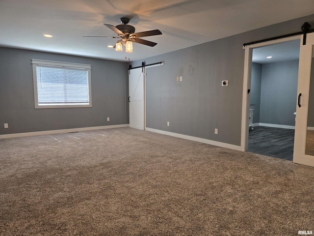 102 Conch Dr, La Harpe, IL 61450 - unfurnished bedroom featuring a barn door, carpet floors, recessed lighting, and a ceiling fan