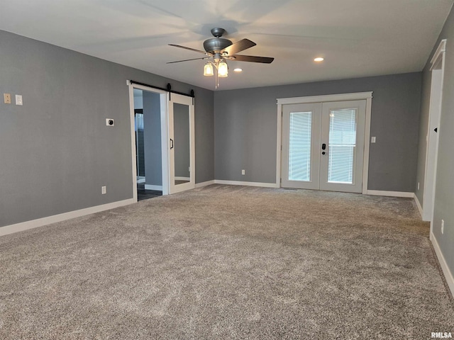 102 Conch Dr, La Harpe, IL 61450 - empty room with french doors, a ceiling fan, carpet floors, a barn door, and recessed lighting