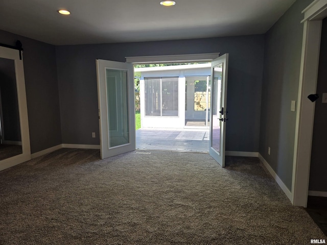 102 Conch Dr, La Harpe, IL 61450 - unfurnished room featuring carpet flooring, recessed lighting, a barn door, and french doors