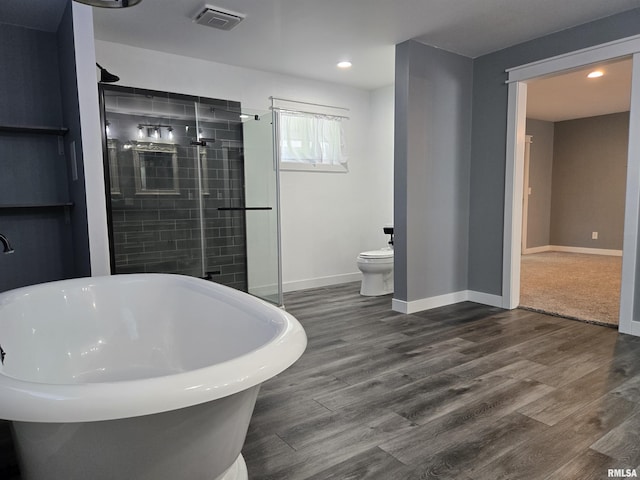 102 Conch Dr, La Harpe, IL 61450 - full bath with a freestanding tub, a shower stall, wood finished floors, and recessed lighting