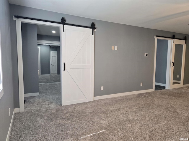 102 Conch Dr, La Harpe, IL 61450 - empty room with a barn door and carpet floors