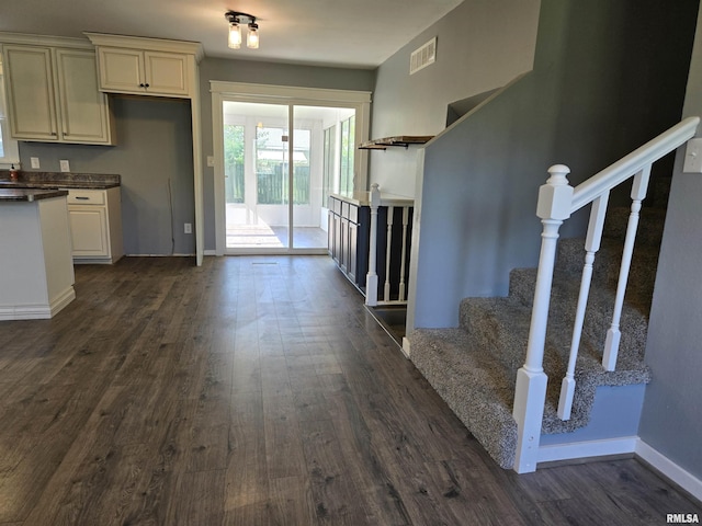 102 Conch Dr, La Harpe, IL 61450 - kitchen featuring dark wood-style flooring, dark countertops, and white cabinetry