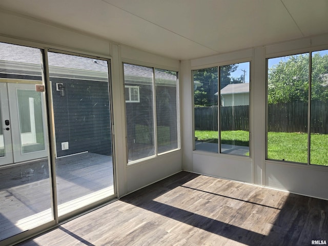 102 Conch Dr, La Harpe, IL 61450 - unfurnished sunroom with wood finished floors, a deck, and french doors