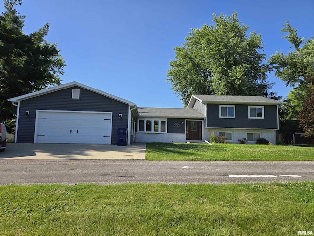 102 Conch Dr, La Harpe, IL 61450 - split level home featuring a garage, concrete driveway, and a front yard