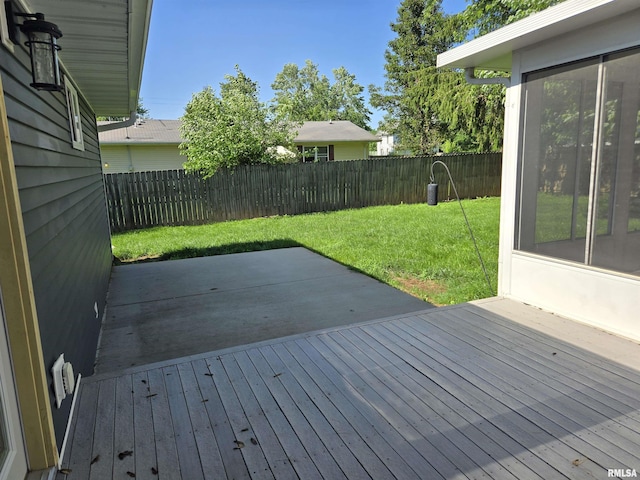 102 Conch Dr, La Harpe, IL 61450 - wooden deck featuring a fenced backyard, a sunroom, and a patio