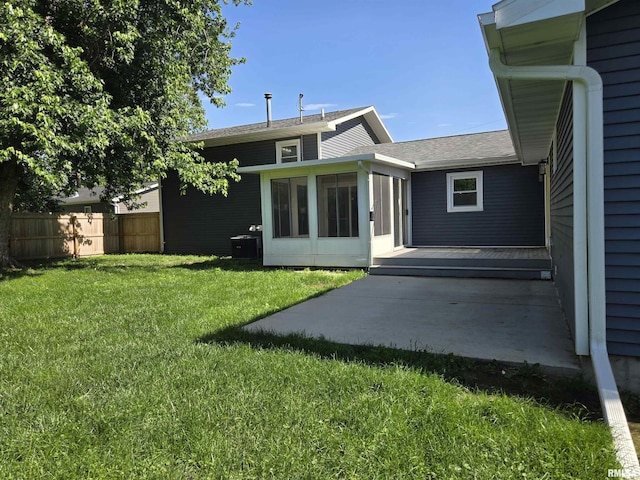 102 Conch Dr, La Harpe, IL 61450 - back of property with a sunroom, a patio area, and a shingled roof