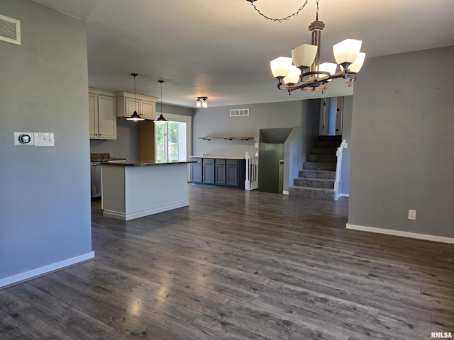 102 Conch Dr, La Harpe, IL 61450 - kitchen with open floor plan, dark countertops, a chandelier, dark wood finished floors, and a kitchen island