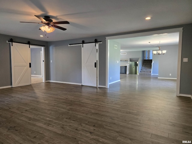102 Conch Dr, La Harpe, IL 61450 - unfurnished living room featuring a barn door, ceiling fan, dark wood finished floors, a chandelier, and recessed lighting