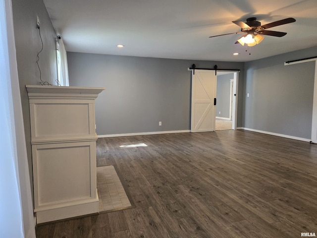 102 Conch Dr, La Harpe, IL 61450 - unfurnished room featuring a barn door, a ceiling fan, dark wood finished floors, and recessed lighting
