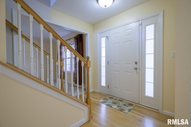1508 W Meadowview Dr, Dunlap, IL 61525 - foyer with wood finished floors, stairway, and a textured ceiling