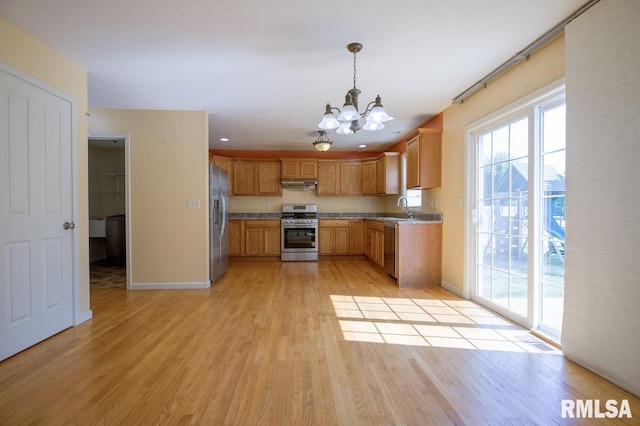 1508 W Meadowview Dr, Dunlap, IL 61525 - kitchen featuring stainless steel appliances, under cabinet range hood, a chandelier, light wood finished floors, and hanging light fixtures