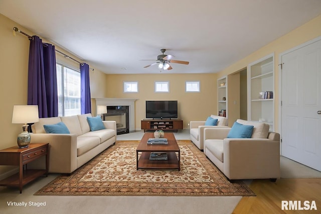 1508 W Meadowview Dr, Dunlap, IL 61525 - living area featuring ceiling fan, a glass covered fireplace, and wood finished floors