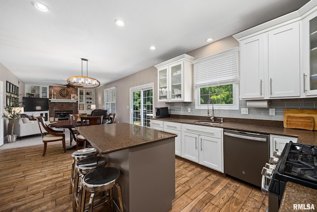 11 Lahood Ln, Washington, IL 61571 - kitchen featuring stainless steel dishwasher, healthy amount of natural light, gas range, dark wood-style flooring, and recessed lighting