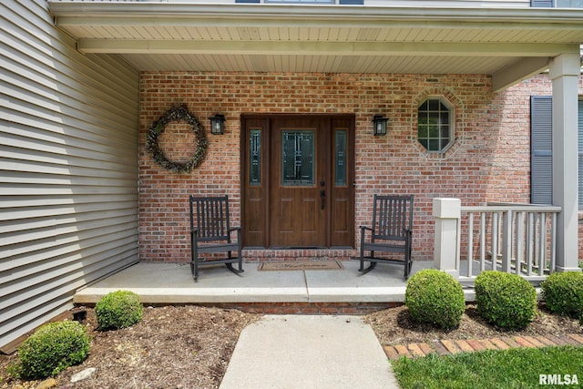 11 Lahood Ln, Washington, IL 61571 - view of exterior entry featuring a porch and brick siding