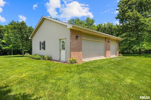 11 Lahood Ln, Washington, IL 61571 - view of side of home featuring brick siding, a yard, and a detached garage