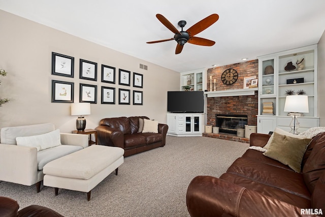 11 Lahood Ln, Washington, IL 61571 - living area with ceiling fan, carpet, a fireplace, and built in shelves