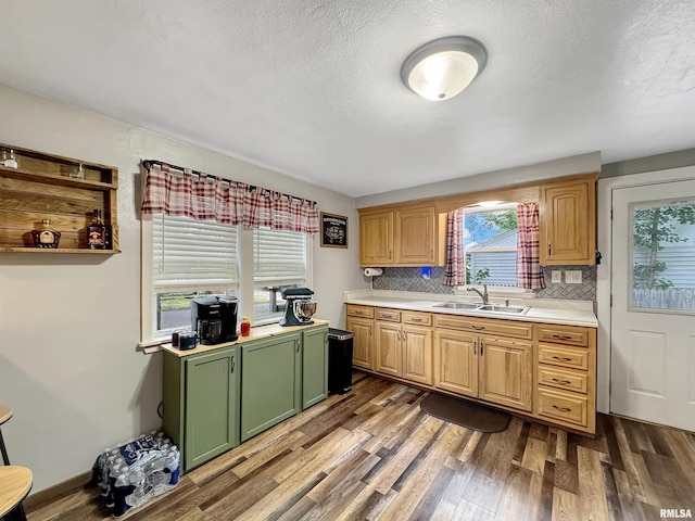 1506 S Capitol St, Pekin, IL 61554 - kitchen with green cabinetry, wood finished floors, light countertops, tasteful backsplash, and a textured ceiling