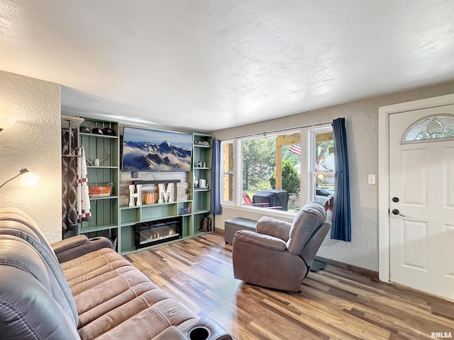 1506 S Capitol St, Pekin, IL 61554 - living room with a textured wall, wood finished floors, plenty of natural light, a textured ceiling, and a glass covered fireplace