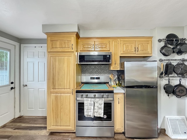 1506 S Capitol St, Pekin, IL 61554 - kitchen featuring stainless steel appliances, backsplash, wood finished floors, and light brown cabinets