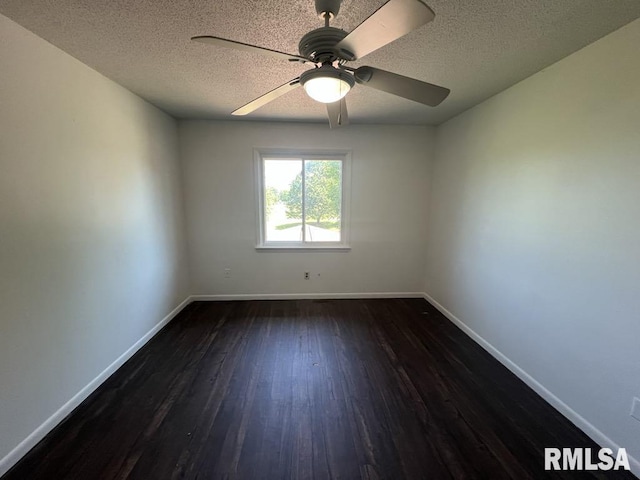 15 Cedar Dr, Macomb, IL 61455 - spare room with dark wood-type flooring, a textured ceiling, and ceiling fan