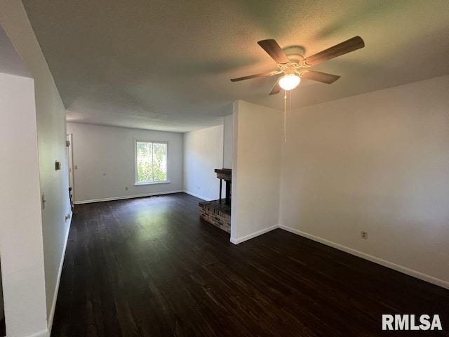 15 Cedar Dr, Macomb, IL 61455 - unfurnished living room featuring dark wood-style floors and a ceiling fan