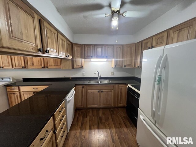 15 Cedar Dr, Macomb, IL 61455 - kitchen featuring white appliances, dark countertops, dark wood-type flooring, and brown cabinetry