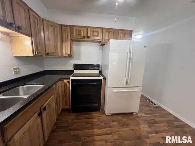 15 Cedar Dr, Macomb, IL 61455 - kitchen with freestanding refrigerator, electric stove, dark wood-type flooring, and brown cabinets