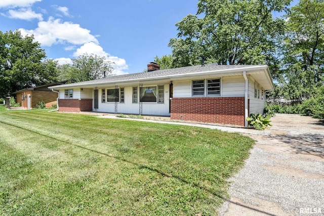 1602 Highwood Ave, Pekin, IL 61554 - ranch-style house featuring brick siding, a front lawn, and a chimney