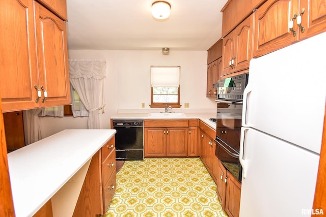1602 Highwood Ave, Pekin, IL 61554 - kitchen featuring black appliances, a warming drawer, light countertops, and brown cabinets