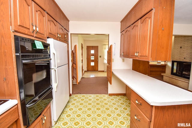 1602 Highwood Ave, Pekin, IL 61554 - kitchen featuring a warming drawer, oven, freestanding refrigerator, light countertops, and a peninsula