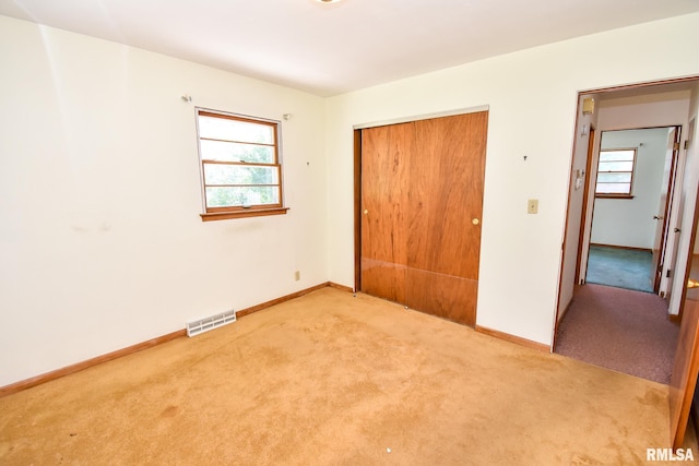 1602 Highwood Ave, Pekin, IL 61554 - unfurnished bedroom featuring light carpet and a closet