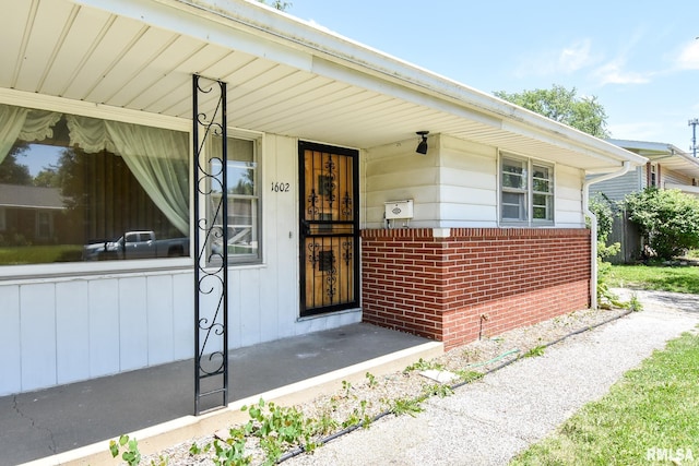 1602 Highwood Ave, Pekin, IL 61554 - doorway to property with brick siding and a porch
