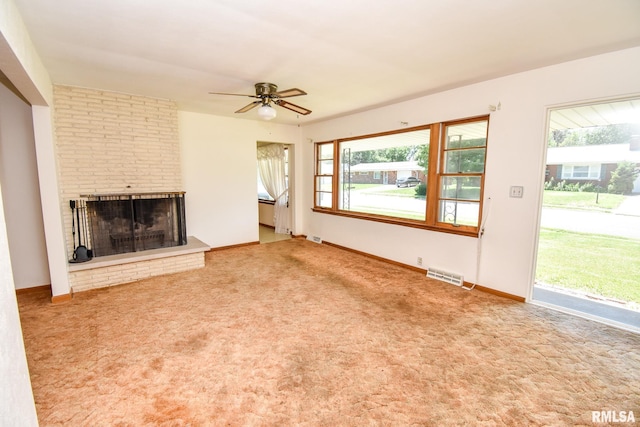 1602 Highwood Ave, Pekin, IL 61554 - unfurnished living room featuring ceiling fan, plenty of natural light, carpet, and a fireplace