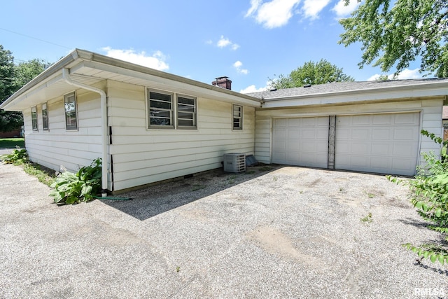 1602 Highwood Ave, Pekin, IL 61554 - view of front of house featuring asphalt driveway, a garage, and a chimney