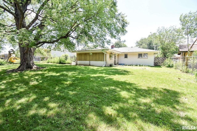 1602 Highwood Ave, Pekin, IL 61554 - back of house with a fenced backyard and a chimney