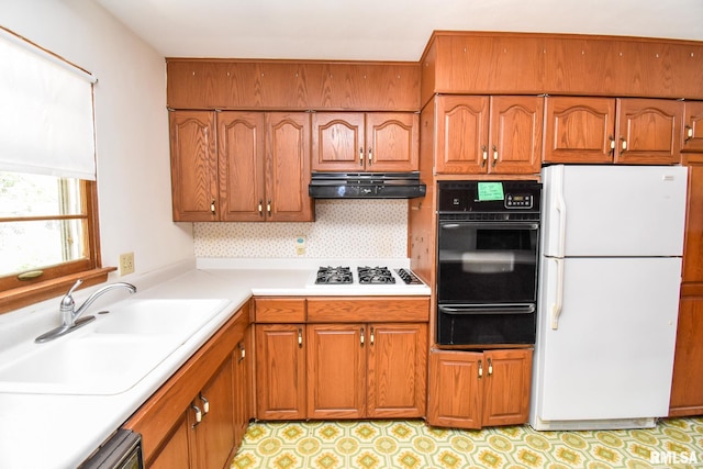 1602 Highwood Ave, Pekin, IL 61554 - kitchen featuring freestanding refrigerator, black oven, a warming drawer, under cabinet range hood, and brown cabinets
