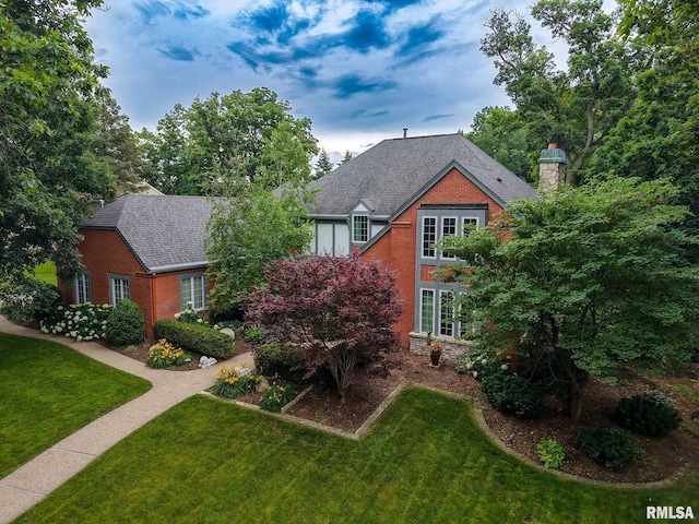 512 Hidden Ln, Peoria, IL 61614 - view of front facade with brick siding, a front yard, and a chimney