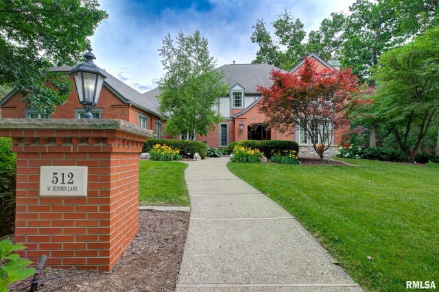 512 Hidden Ln, Peoria, IL 61614 - view of front of house with a front yard and brick siding