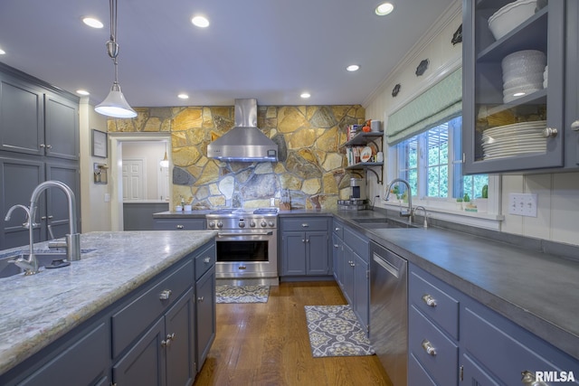 512 Hidden Ln, Peoria, IL 61614 - kitchen featuring appliances with stainless steel finishes, wall chimney range hood, blue cabinetry, open shelves, and pendant lighting