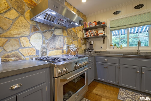 512 Hidden Ln, Peoria, IL 61614 - kitchen featuring high end stainless steel range oven, exhaust hood, gray cabinetry, ornamental molding, and dark countertops