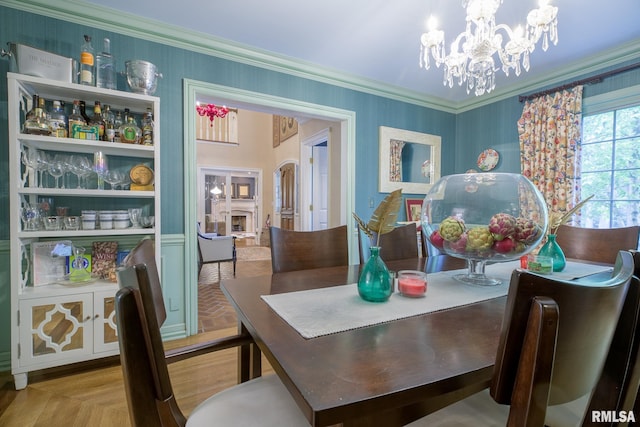 512 Hidden Ln, Peoria, IL 61614 - dining space featuring ornamental molding, a chandelier, a fireplace, and wallpapered walls
