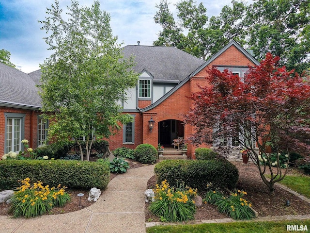 512 Hidden Ln, Peoria, IL 61614 - tudor-style house featuring brick siding and a shingled roof