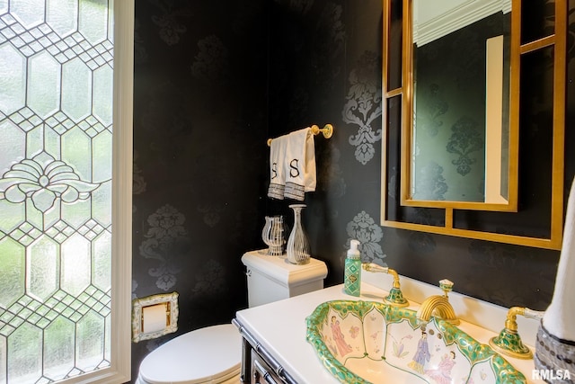 512 Hidden Ln, Peoria, IL 61614 - half bathroom featuring vanity and wallpapered walls