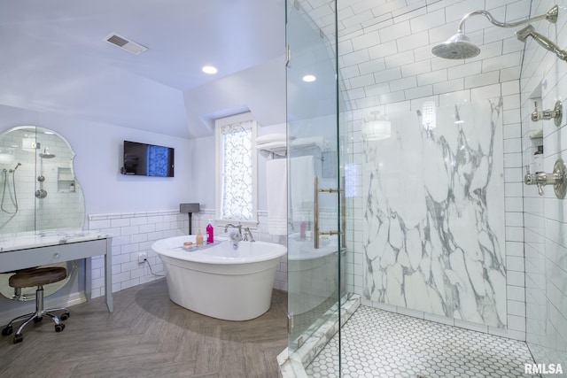 512 Hidden Ln, Peoria, IL 61614 - bathroom featuring tile walls, a shower stall, a freestanding bath, wainscoting, and recessed lighting