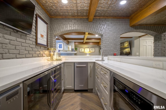 512 Hidden Ln, Peoria, IL 61614 - indoor dry bar with beverage cooler, arched walkways, an ornate ceiling, beamed ceiling, and brick wall